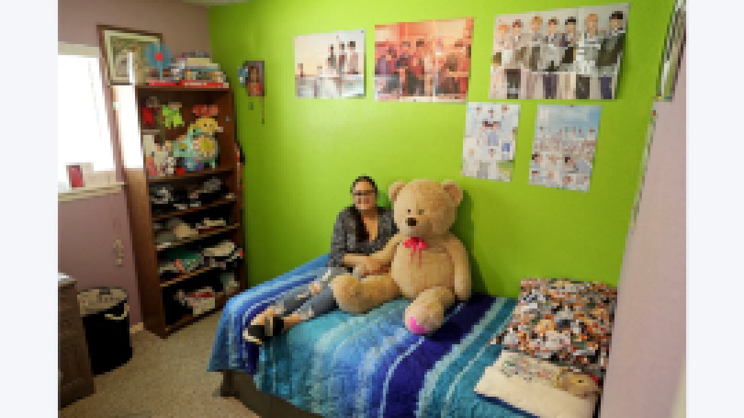 Maytee on bed with teddy bear