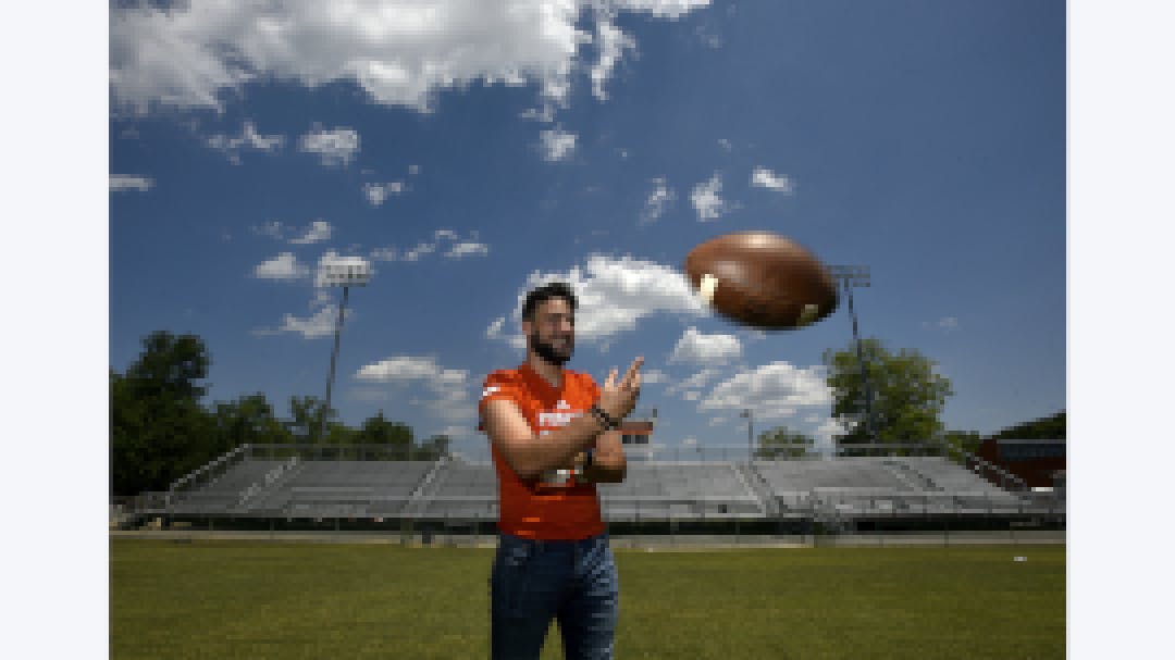 Dino throwing football