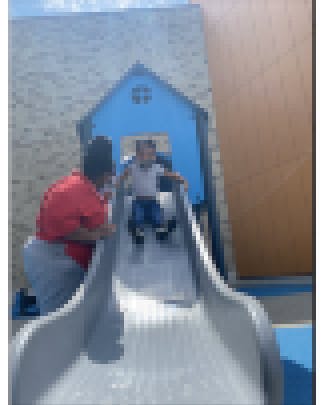 Teacher and child on slide